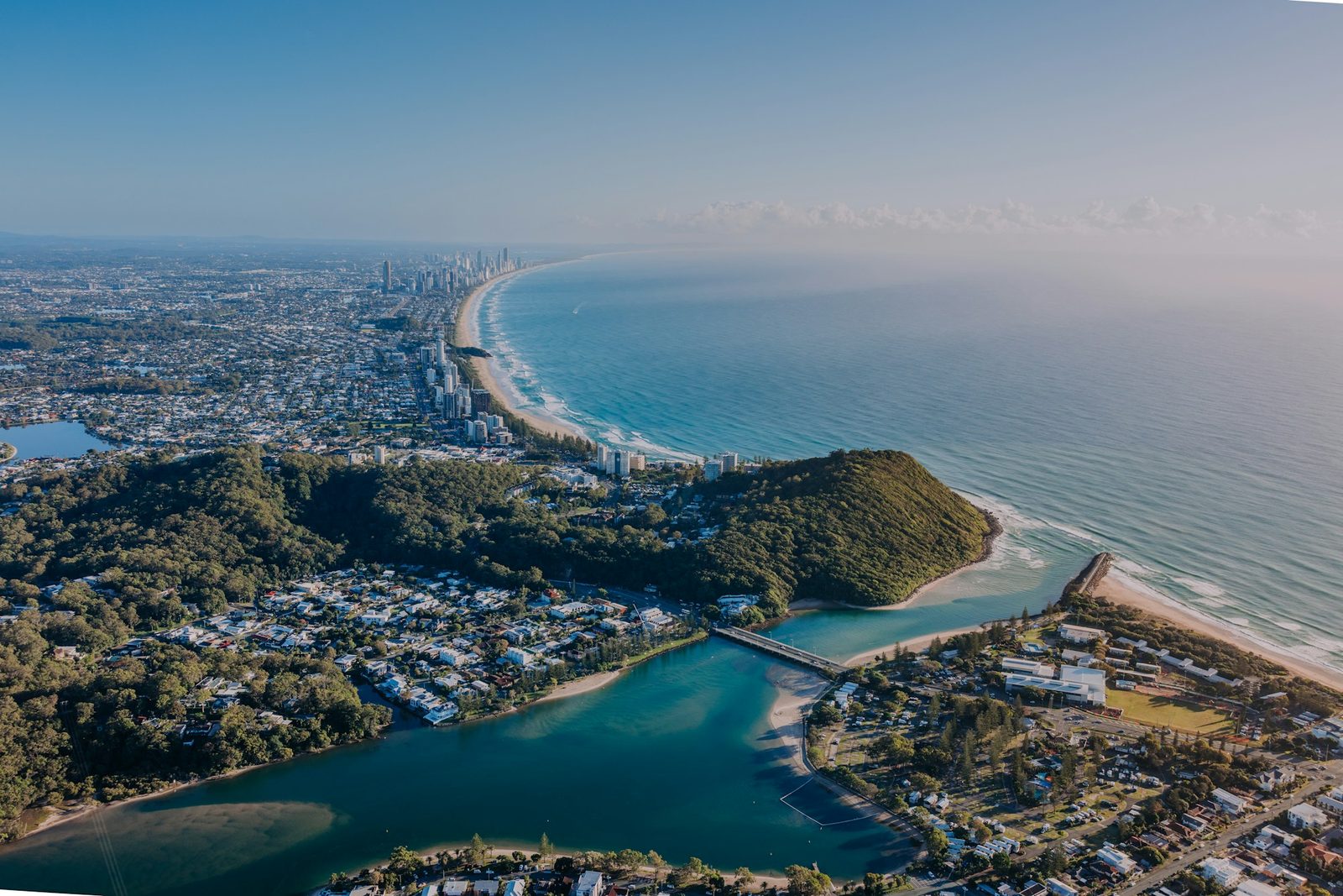 Aerial view of the southern Gold Coast coastline, creek and green hinterland hills
